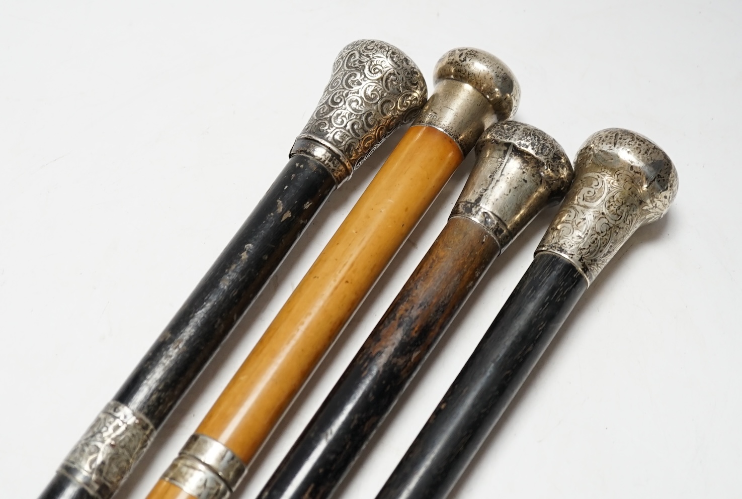 Four Victorian silver mounted handled walking sticks: one being a sword stick, sword stick 90cm long
